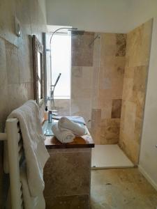 a bathroom with a shower and a sink with towels at Palazzo Pisani Malta B&B in Żabbar