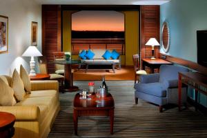 a living room with a couch and a table at Dead Sea Marriott Resort & Spa in Sowayma