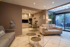 a living room with a couch and a table at MAISON GAMBETTA in Deauville