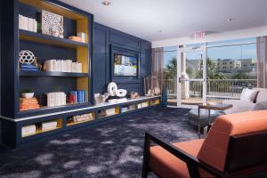 a living room with blue walls and a couch at Courtyard Charleston Waterfront in Charleston