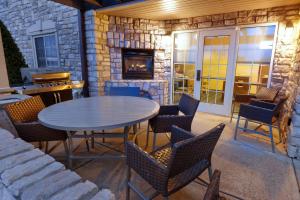 a patio with a table and chairs and a fireplace at TownePlace Suites Joplin in Joplin