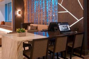an office with a desk with a laptop on it at Chicago Marriott Southwest at Burr Ridge in Burr Ridge