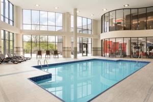 a large swimming pool in a building with glass windows at Courtyard by Marriott Toronto Mississauga/West in Mississauga