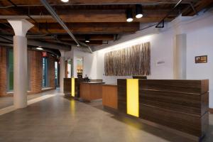 a lobby of a building with wooden reception desks at Residence Inn by Marriott Boston Downtown Seaport in Boston