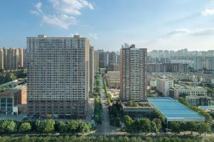 an aerial view of a city with tall buildings at W Changsha in Changsha