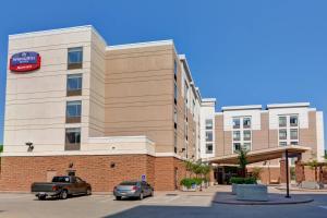 a building with a car parked in front of it at SpringHill Suites by Marriott Cincinnati Midtown in Cincinnati