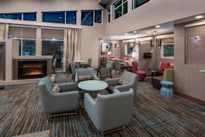 a lobby with couches and chairs and a fireplace at Residence Inn by Marriott Dallas at The Canyon in Dallas