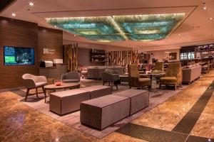 a lobby with chairs and tables in a hotel at Courtyard by Marriott Mexico City Revolucion in Mexico City