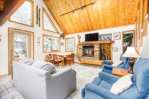 a living room with two couches and a fireplace at Snowbird Chalet #5 in Girdwood