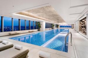 a swimming pool in a hotel with windows at Hotel Onoma Daejeon, Autograph Collection in Daejeon