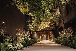 a walkway in a building with lights and flowers at Hotel Onoma Daejeon, Autograph Collection in Daejeon
