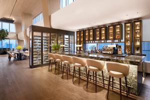 a bar in a restaurant with chairs and a bar counter at Hotel Onoma Daejeon, Autograph Collection in Daejeon