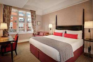 a hotel room with a large bed and a desk at St. Ermin's Hotel, Autograph Collection in London