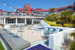 an outdoor patio with tables and chairs in front of a house at Laguna Cliffs Marriott Resort & Spa in Dana Point