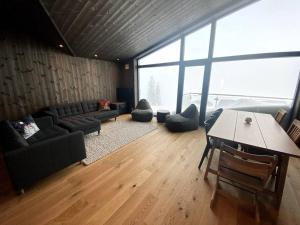 a living room with a couch and a table at Cosy apartment with ski in/out in Noresund