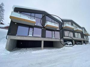 une maison dans la neige avec deux miroirs sur elle dans l'établissement Cosy apartment with ski in/out, à Noresund