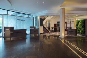 a lobby of a building with a sign that reads westin at The Westin Grand Munich in Munich