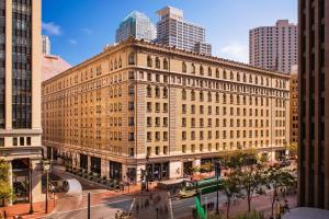 a large building in the middle of a city at Palace Hotel, a Luxury Collection Hotel, San Francisco in San Francisco
