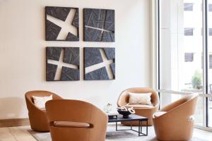 two chairs and a coffee table in a living room at AC Hotel by Marriott Atlanta Perimeter in Atlanta