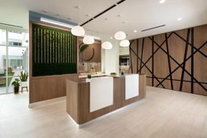 a lobby with a bar with a green wall at Element Austin at The Domain in Austin