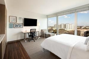 a hotel room with a bed and a desk with a computer at Element Austin at The Domain in Austin