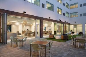 a patio with tables and chairs and a building at Element Austin at The Domain in Austin