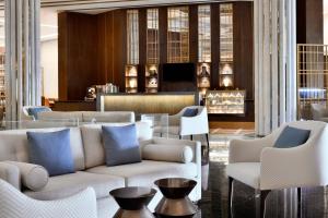 a lobby with a couch and chairs in a room at Riyadh Airport Marriott Hotel in Riyadh