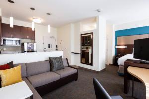 a living room with a couch and a bedroom at Residence Inn by Marriott Oklahoma City Airport in Oklahoma City