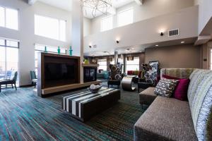 a living room with a couch and a tv at Residence Inn by Marriott Oklahoma City Airport in Oklahoma City