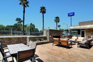 a patio with tables and chairs and a fireplace at Fairfield Inn & Suites by Marriott Los Angeles Rosemead in Rosemead