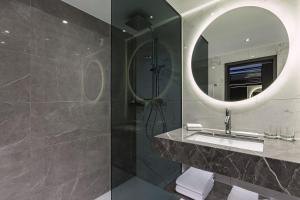 a bathroom with a sink and a mirror at The Westin Grand Berlin in Berlin