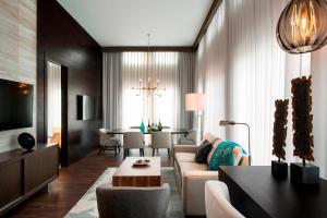 a living room with a couch and a table at Courtyard by Marriott Calgary South in Calgary