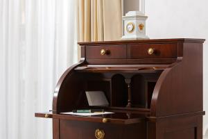 a wooden desk with a clock on top of it at The Westin Grand Berlin in Berlin
