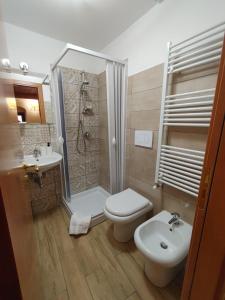 a bathroom with a shower and a toilet and a sink at Borgo Sciugolo in Baselice