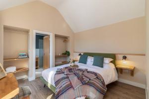 a bedroom with a large bed and a couch at Green End Farm Cottages - The Sheep Shed in Whitby
