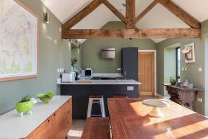 a kitchen with a table and a counter top at Green End Farm Cottages - The Sheep Shed in Whitby