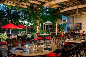 an outdoor restaurant with tables and chairs and umbrellas at Sacramento Marriott Rancho Cordova in Rancho Cordova