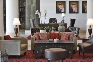 a living room with a couch and a table and chairs at Al Manara, a Luxury Collection Hotel, Aqaba in Aqaba