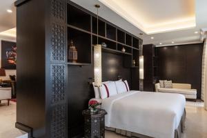 a bedroom with a white bed and a black wall at Al Manara, a Luxury Collection Hotel, Aqaba in Aqaba