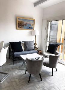 a living room with a couch and chairs and a table at Neptuna- 52B- Appart spacieux- 7 pers in Cap d'Agde