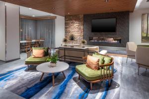 a lobby with a living room with a fireplace at Fairfield by Marriott Inn & Suites Somerset in Somerset