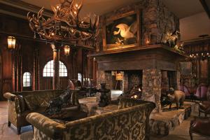 a living room with a couch and a stone fireplace at Grand Bohemian Hotel Asheville, Autograph Collection in Asheville