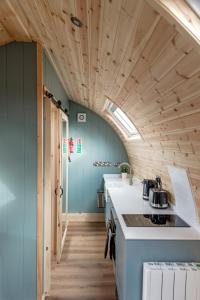 a kitchen with a wooden ceiling and a counter top at Country Glamping in Bishop Auckland