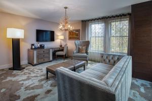 a living room with a couch and a desk at Grand Bohemian Hotel Asheville, Autograph Collection in Asheville
