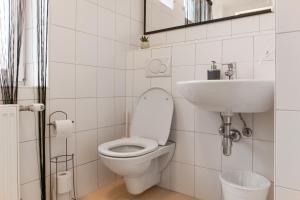a bathroom with a toilet and a sink at comfortable 2BR Apt.-Near Wiener Stadthalle in Vienna
