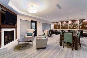 a dining room with a fireplace and a table and chairs at TownePlace Suites by Marriott Slidell in Slidell