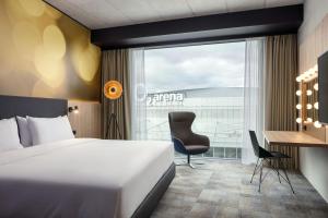 a hotel room with a bed and a desk and a window at STAGES HOTEL Prague, a Tribute Portfolio Hotel in Prague
