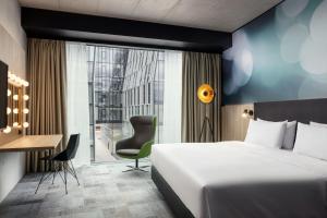 a hotel room with a bed and a desk at STAGES HOTEL Prague, a Tribute Portfolio Hotel in Prague