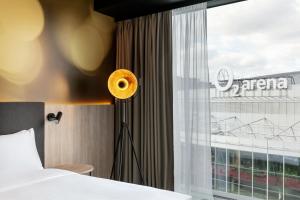 a hotel room with a bed and a window at STAGES HOTEL Prague, a Tribute Portfolio Hotel in Prague