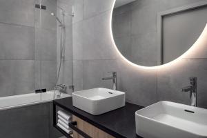 a bathroom with a white sink and a mirror at STAGES HOTEL Prague, a Tribute Portfolio Hotel in Prague